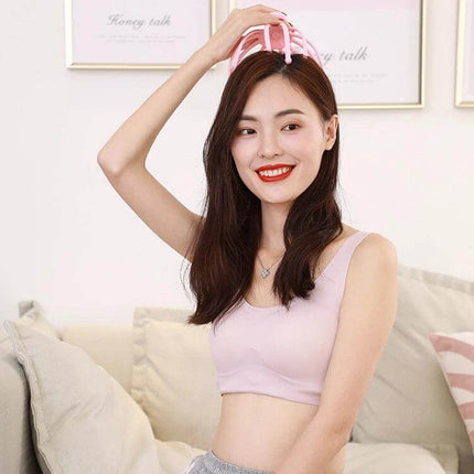 12 Claw Head Massager Octopus With Rotating Ball For Scalp Relaxation shown in use by smiling woman holding pink octopus massager over her head