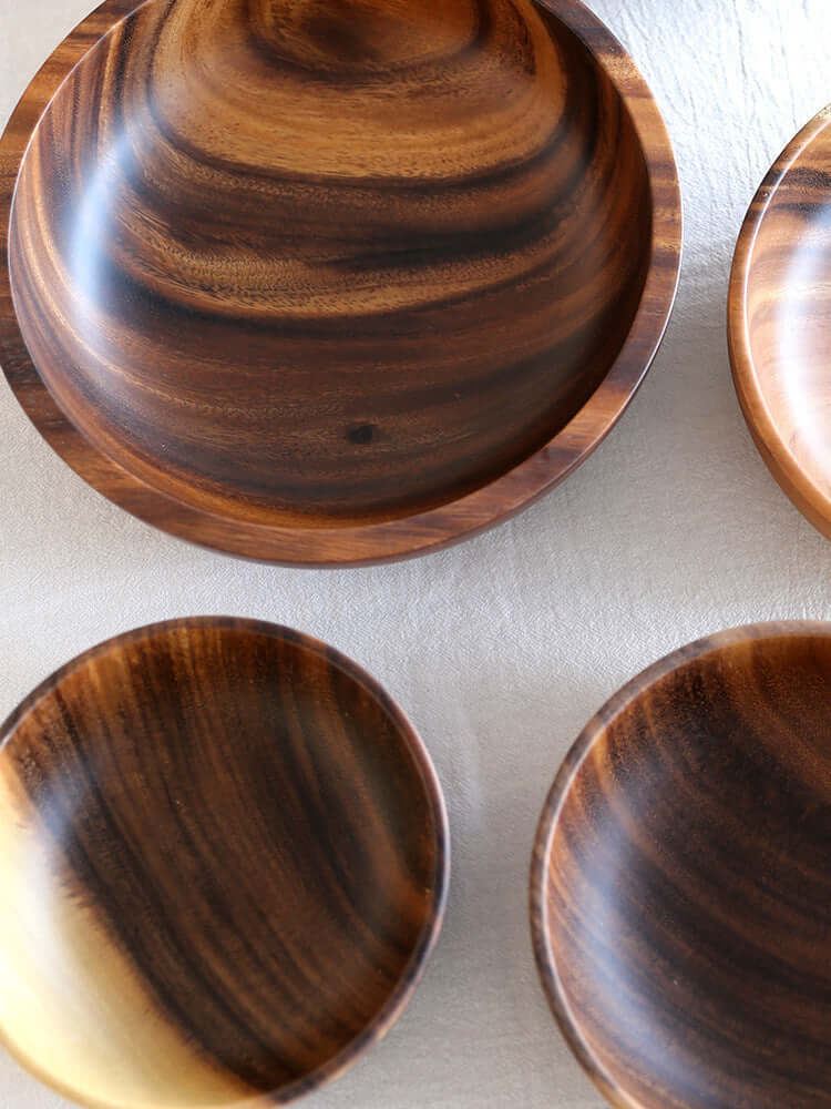 Handcrafted Acacia wood bowls in various sizes showcasing elegant design and natural wood grain.