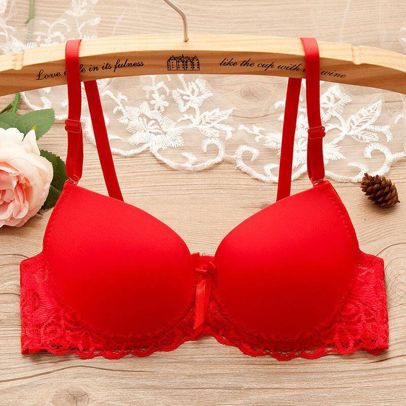 Red underwire gathered bra for small bust with lace and bow details on wooden hanger with floral decor