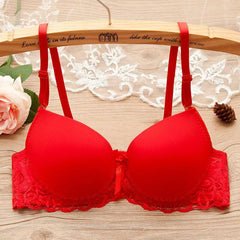 Red underwire gathered bra for small bust with lace and bow details on wooden hanger with floral decor