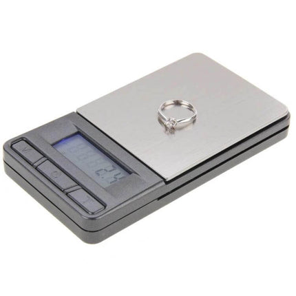 2-In-1 Pocket Jewelry Scale With Calculator And LCD showing ring on stainless steel platform and blue-backlit LCD, compact travel jeweler scale