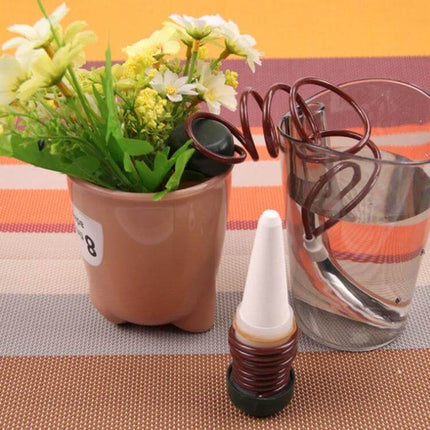 2 Pack Automatic Plant Watering Drip Kit For Potted Plants showing porcelain tip, tubing and reservoir next to potted flowers