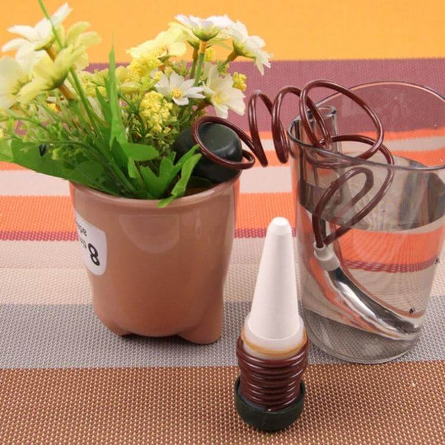 2 Pack Automatic Plant Watering Drip Kit For Potted Plants showing porcelain tip, tubing and reservoir next to potted flowers