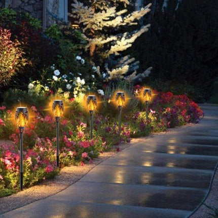 2-Pack Outdoor Solar Flame Lights for Courtyard Lawn along garden pathway, warm LED flame effect on stakes for evening decorative lighting
