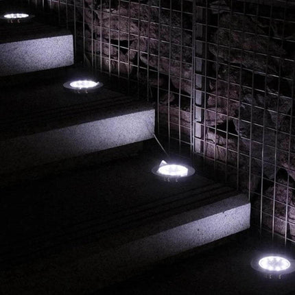 2 Pack Solar Underground Garden Lights For Walkways installed flush in steps and along a stone wall, automatic night illumination guiding path safely