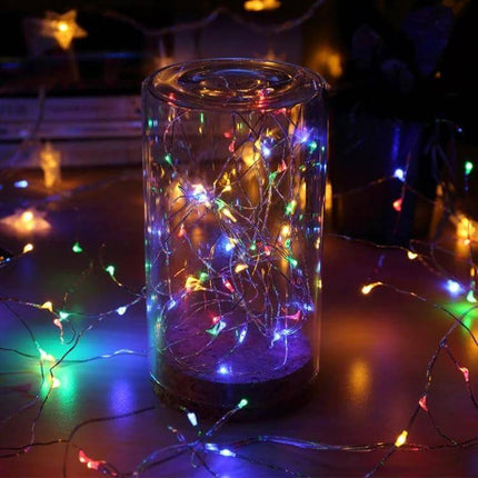 20m Solar String Lights Fairy Lamp For Outdoor Decor glowing multicolor fairy lights inside glass jar on patio at night