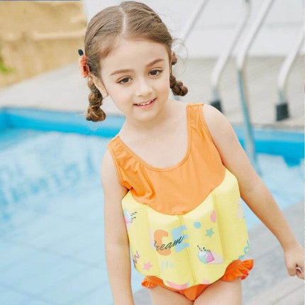 Yellow Graffiti One-Piece Swimsuit with Buoyancy for Baby Girls on a smiling toddler by pool wearing yellow buoyant one-piece
