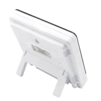 3.8 Inch LCD Temperature and Humidity Meter with Clock white rear view on stand showing battery compartment and wall mount slot