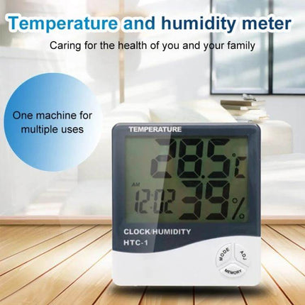 3.8 Inch LCD Temperature and Humidity Meter with Clock displaying indoor temp 28.5°C and 39% humidity on a tabletop in living room