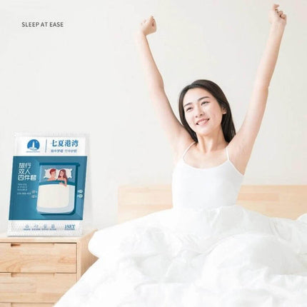 3-In-1 Travel Hotel Disposable Bedding Set For One Person displayed next to smiling traveler in a white bed, pre-sterilized vacuum-packed single-use bedding