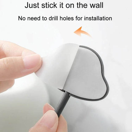 3-Piece Adhesive Wall Hooks Set, Non-Marking, Ideal For Home Or Dorm adhesive no-drill hook being stuck to wall showing peel-and-stick installation