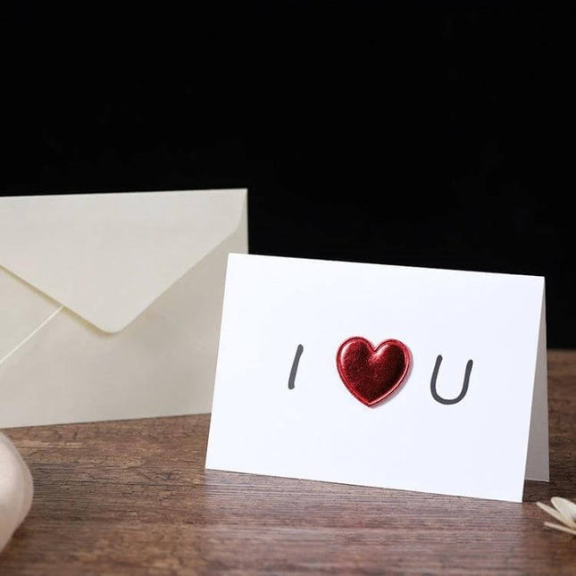 3D Heart Valentine Day Greeting Card With Envelopes showing white card with red 3D heart and matching envelope on wooden table