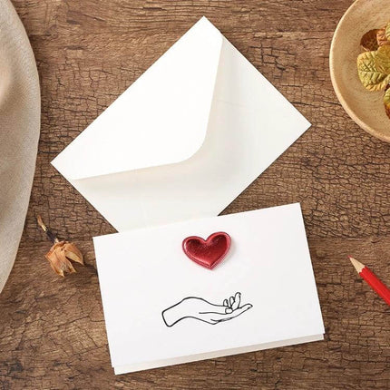 3D Heart Valentine Day Greeting Card With Envelopes showing white card with red 3D heart and matching envelope on wooden table