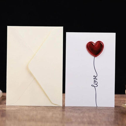 3D Heart Valentine Day Greeting Card With Envelopes featuring red heart balloon design and matching envelope on wooden table