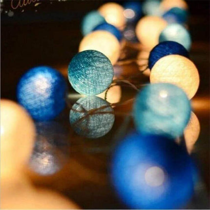 3M Cotton Ball String Lights For Holiday Decor 20 LEDs soft blue and white cotton ball LED string lights draped on reflective surface
