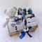 Infant Unisex Clothes Set for Autumn and Winter Gift Box displayed in a cozy wicker gift basket with plush bear and navy ribbon
