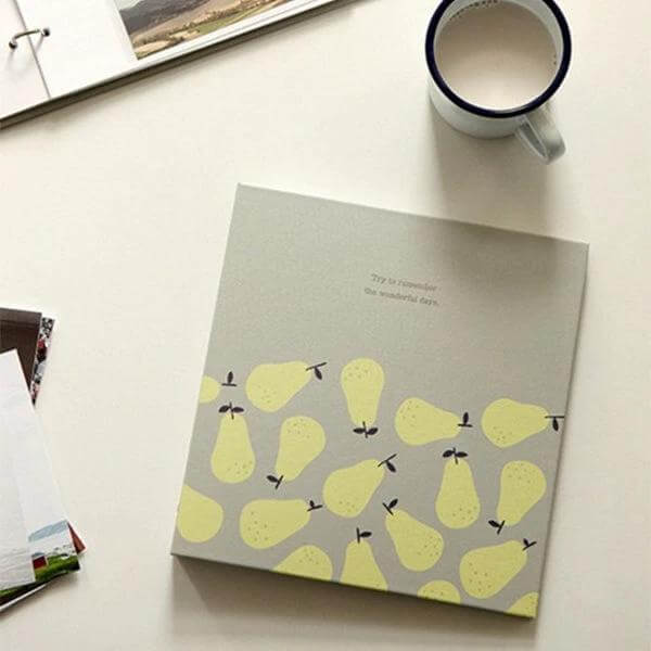Photo Album 5 Inch Family Keepsake For Storing Memories compact pear-patterned 5-inch photo album on table with coffee cup, ideal gift for family keepsakes