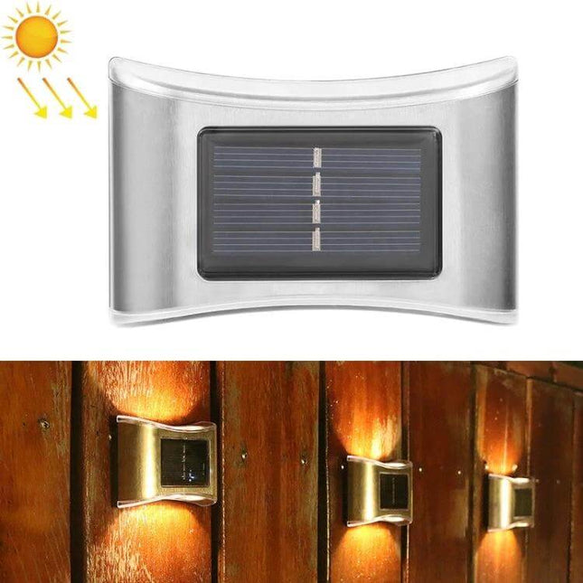 6 LED Solar Outdoor Garden Wall Lamp, Stainless Steel mounted on wooden fence showing solar panel and warm LED pathway lighting