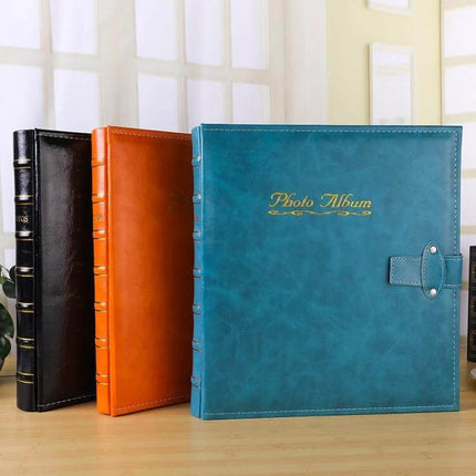 6-Inch PU Leather Photo Album With Bronzing Cover showing teal, orange, and black albums with bronzed title and bamboo-stamped finish, holds up to 500 photos