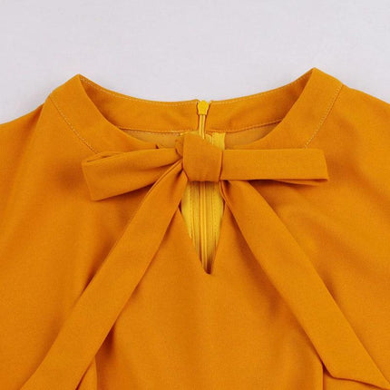 Women's Floral Dress for Casual Everyday Outings - close-up of mustard bow neckline on polyester-spandex blend dress