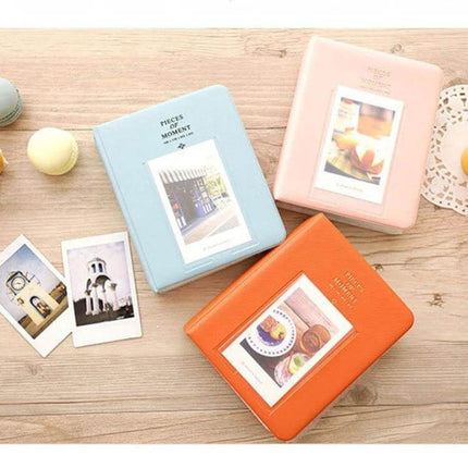 64-Pocket Instax Mini Photo Album For Your Memories - pastel blue pink orange albums with sample Instax prints on wooden table