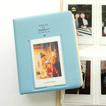 64-Pocket Instax Mini Photo Album For Your Memories light blue album with front photo slot and instax prints arranged