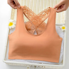 Seamless No-Rims Latex Women's Comfort Bra in peach with lace detail, displayed on a white basket with flowers