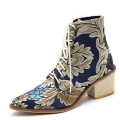 Blue embroidered satin ankle boots with high chunky heels and distinctive ethnic patterns.