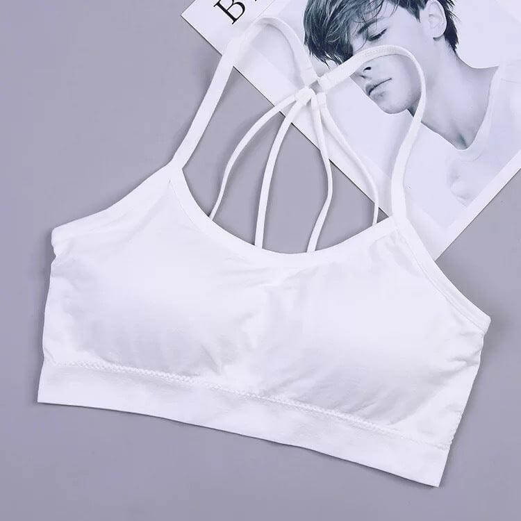 White nylon tube top bra for girls with wireless design, displayed on a grey background with a magazine.