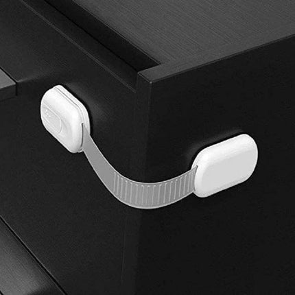 Adjustable Slide Baby Safety Lock for Cabinets and Drawers on black dresser showing slim white ABS strap lock preventing drawer access