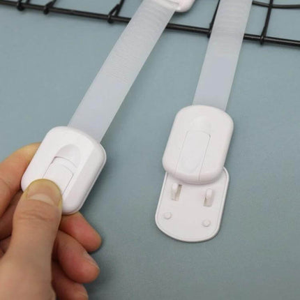 Adjustable Slide Baby Safety Lock for Cabinets and Drawers shown in white ABS with slim straps securing cabinet and drawer doors
