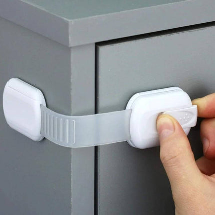 Adjustable Slide Baby Safety Lock for Cabinets and Drawers on grey dresser preventing toddler access to drawer with slim ABS strap