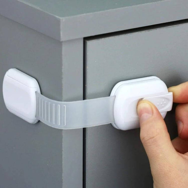 Adjustable Slide Baby Safety Lock for Cabinets and Drawers on grey dresser preventing toddler access to drawer with slim ABS strap