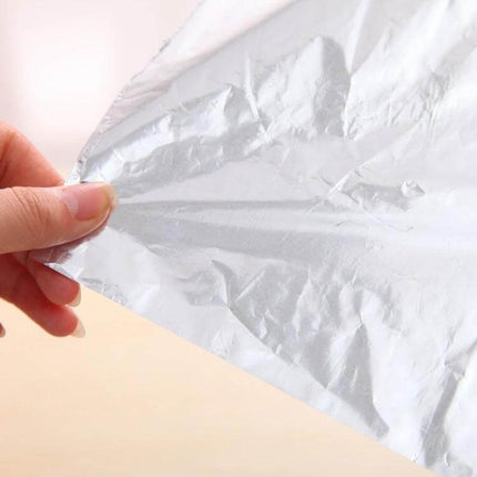 Aluminum Foil Roll 5m For Baking And Barbecue Non Toxic - hand holding sheet of food-grade aluminum foil for oven and grill use