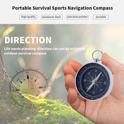 Aluminum Hiking Compass With Keychain For Camping And Outdoors - compact aluminum navigation compass with keyring held in hand, ideal for hikers and emergency kits