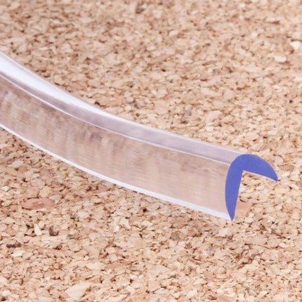 Baby Safety Desk Table Edge Guard Soft Edge Cushion 1m Length clear corner protector strip on cork surface, soft U-shaped edge guard for tables