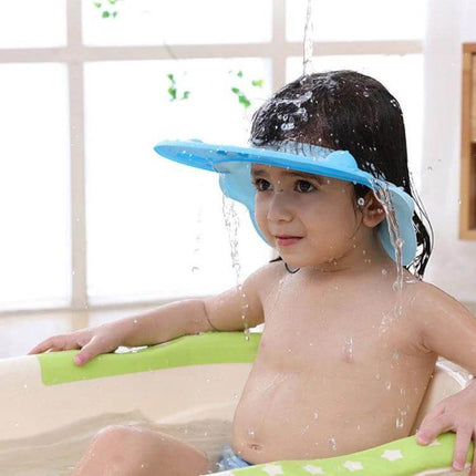 Baby Shower Cap With Adjustable Fit For Bath Time Use - child wearing blue adjustable shower cap protecting eyes during bath