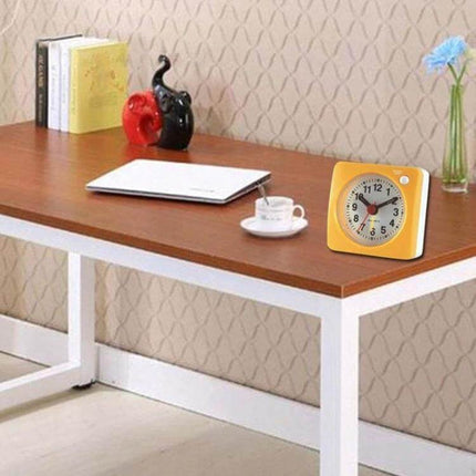Bedside Mute Alarm Clock With Light For Nightstand compact yellow travel quartz clock on desk next to laptop and cup