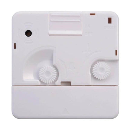 Bedside Mute Alarm Clock With Light For Nightstand compact white travel quartz clock back view with controls and gear dials