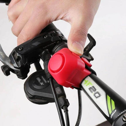 Bicycle Electric Horn With Bell Red Easy To Install No Battery mounted on bike handlebar being pressed by hand