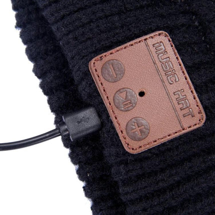 Warm Knitted Beanie with Bluetooth for Everyday Winter Calls - black knit beanie close-up of Bluetooth control patch and charging cable