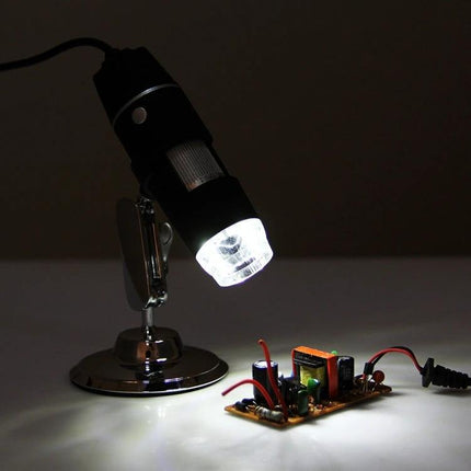 USB Digital Microscope with Adjustable LED for Inspections showing microscope illuminating an electronic circuit on a stand