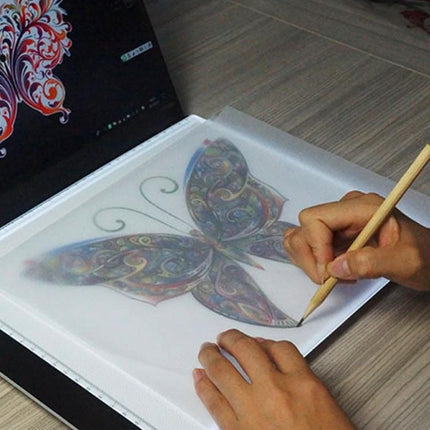 A4 Acrylic Light Board for Sketching and Tracing with Adjustable Brightness showing hands tracing a butterfly design