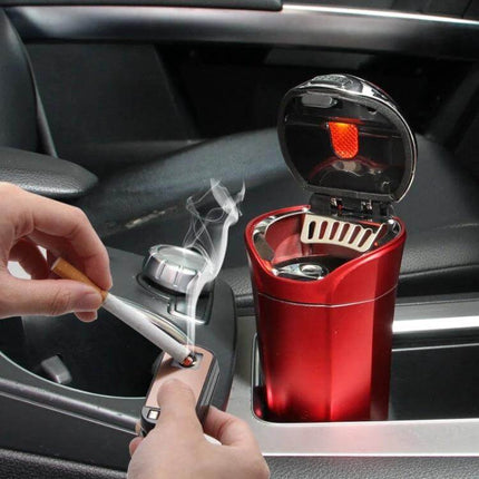 Portable Solar-Powered Car Ashtray with LED Light and Cover shown in car cup holder with LED on and hands using lighter
