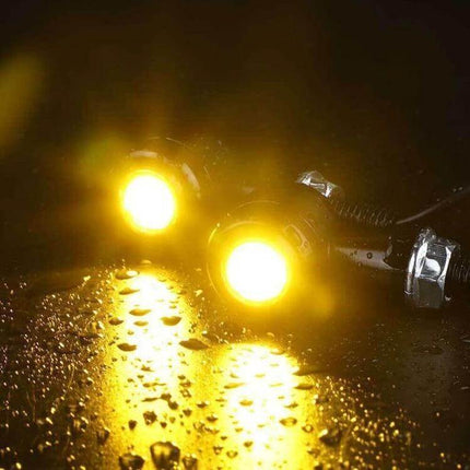Pair of Mini Motorcycle Turn Signals for Easy Replacement - compact amber LED indicators shown illuminated on wet surface