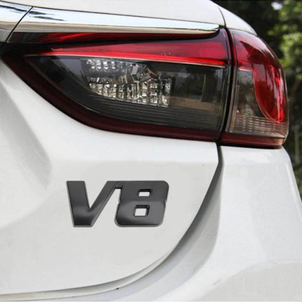 V8 Connect Shape Metal Car Body Sticker, Size S Black on white sedan trunk near taillight showing compact metal V8 emblem