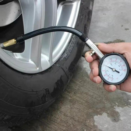 Tire Pressure Gauge for Daily Vehicle Checks and Travel — hand-held analog gauge checking car tire pressure on roadside