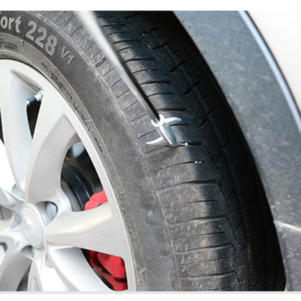 Portable Car Tire Cleaning Hook Black Orange For Everyday Use shown cleaning tread grooves on a car tire with metal-core hook