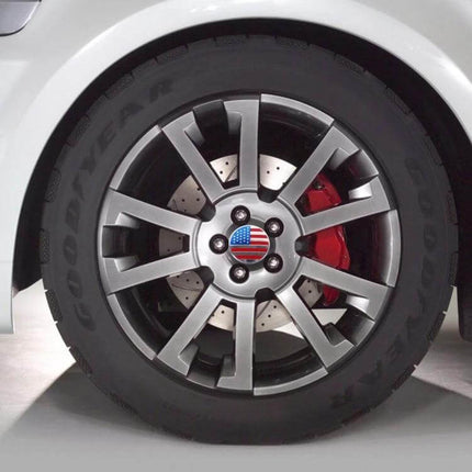 USA Flag Metal Stickers for Car Wheel Hub Caps, 4 Pack - close-up of American flag metal sticker on silver car wheel hub cap