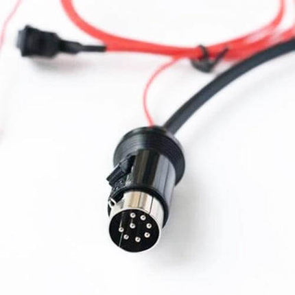 Car 8 Pin Wireless Bluetooth AUX Audio Adapter For Nissan plugged into Nissan CD changer port, Bluetooth 5.0 cable and 8-pin connector visible